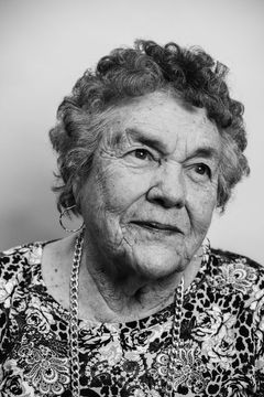 A duotoned black-and-white portrait of Caroline Basye Romero.