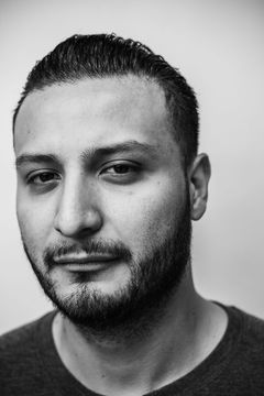 A duotoned black-and-white portrait of Jesus Huerta.