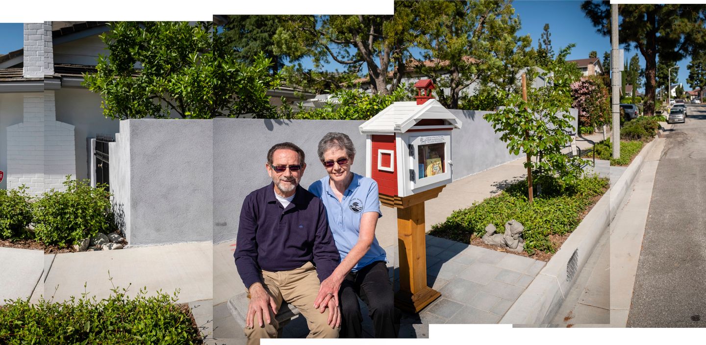 Long-time residents of Rowland Heights, CA, Teri and David Malkin, sit for a portrait on the bench  next to the free lending library they installed in front of their home.