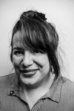 A duotoned black-and-white portrait of Victoria Bernal.