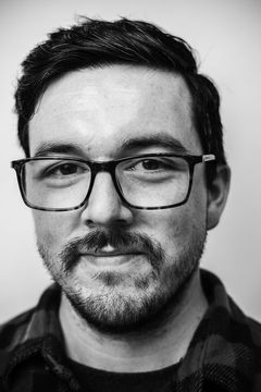 A duotoned black-and-white portrait of Alex Araiza.