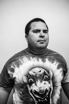 A duotoned black-and-white portrait of Paul Neal.
