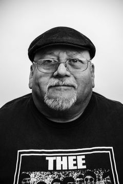 A duotoned black-and-white portrait of Henry Pedregon.