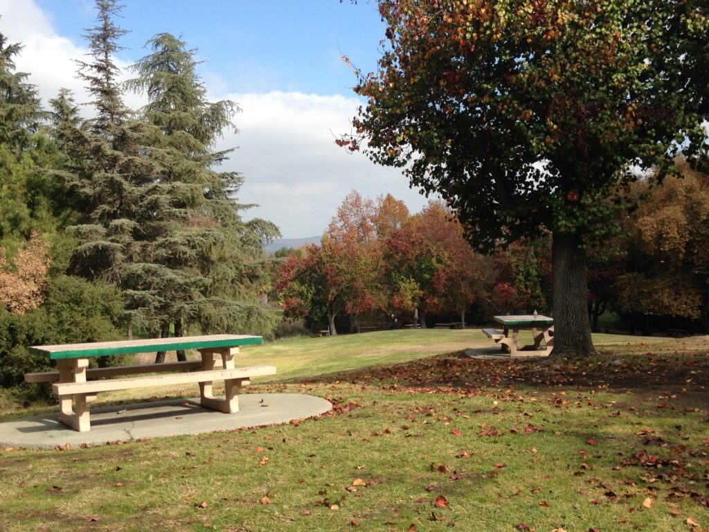 Picture of Schabarum Park. Picture shows a table, lawn, trees, and sky