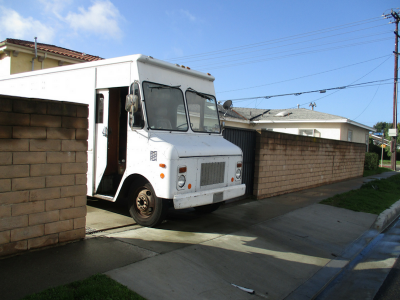 Photo 17: A step van is parked within the driveway of a residential property.
