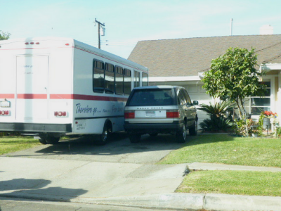 Photo 20: A shuttle bus is parked within the driveway of a residential property.