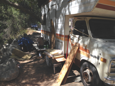 Photo 28: A motorhome and its occupant’s personal items are maintained on a vacant property.