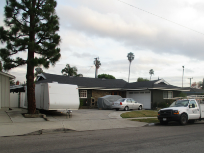 Photo 14: A fifth wheel accessory trailer is parked within in the driveway.