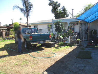 Photo 12: A pickup truck is parked on the lawn within the required front yard area.